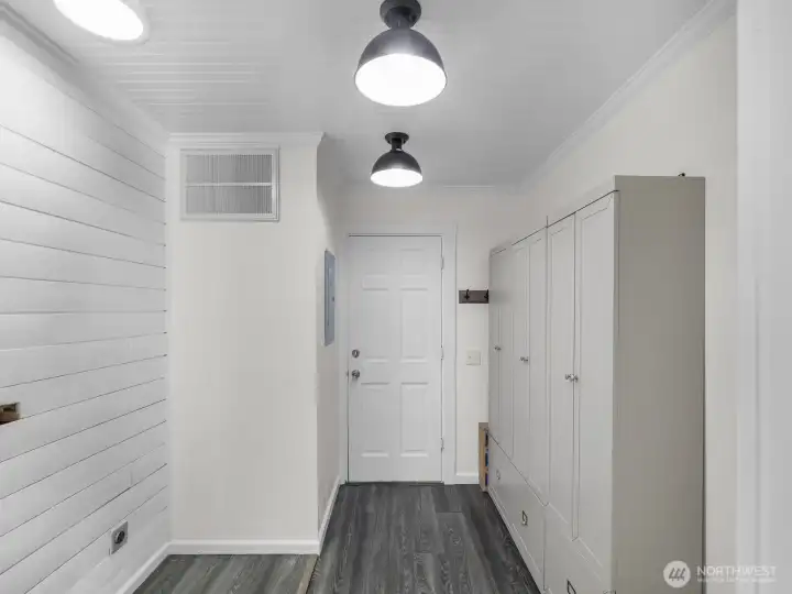 Utility room w/ large cabinets for extra storage.