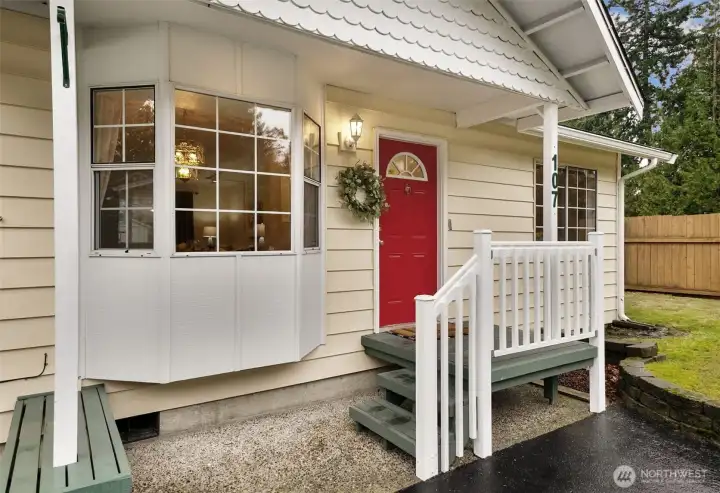 Charming covered entry with built-in bench. Approaching the home, it's clear the owners have meticulously cared for the home and surrounding property.