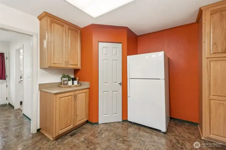 From the spacious kitchen, the convenient walk-through to the utility room (to the left) connects the back entry to the kitchen—perfect for easy grocery drop-off and storage.