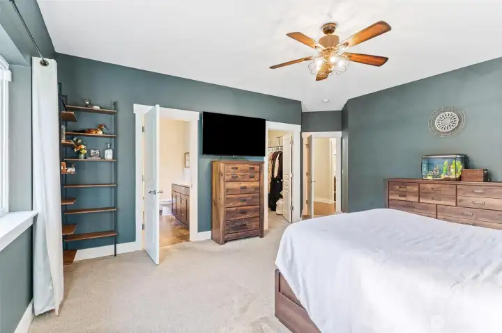 View of large primary 5 suite bathroom and expansive walk-in closet.