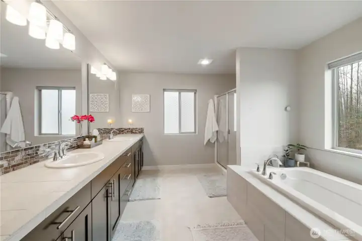 Large primary en suite with large double vanity, soaking tub separate shower