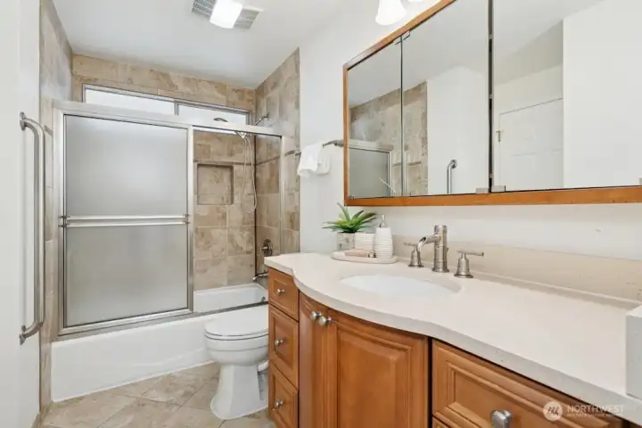 Hallway bathroom with tub. Heated tile floor