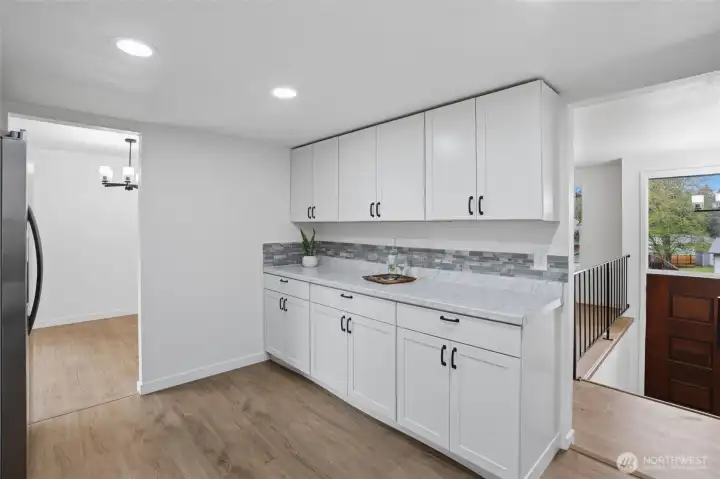 Pretty tile backsplash highlights clean kitchen color scheme