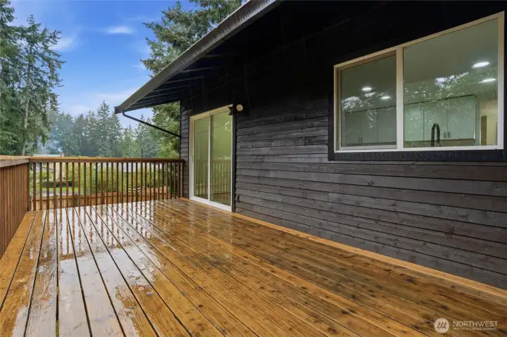 Back deck with slider to kitchen and dining area