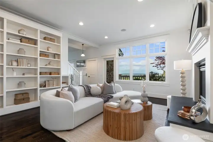 Informal living below the kitchen with terrace access and a gas fireplace.