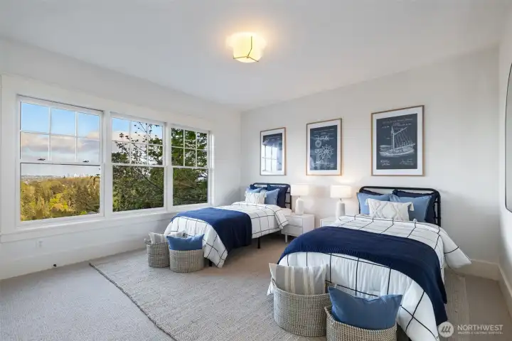 The first of three secondary bedrooms upstairs. Great views and ample closet space.