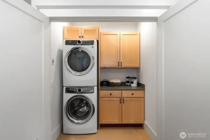 Walk-in laundry room with plenty of room for hampers, folding and storage.