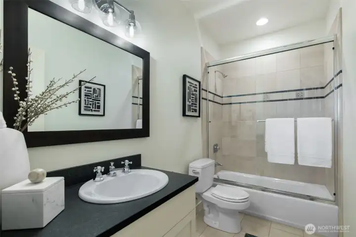 Full bath on the first floor adjacent to the guest room, office and media room.