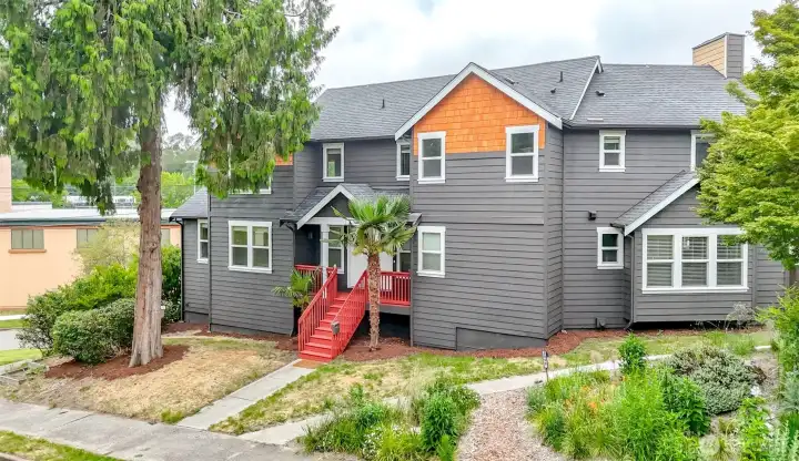 Striking Craftsman-inspired exterior with fresh designer paint, inviting front porch, and exceptional curb appeal on a prominent corner lot.