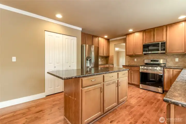 Large center island provides additional prep space, storage, and casual seating.