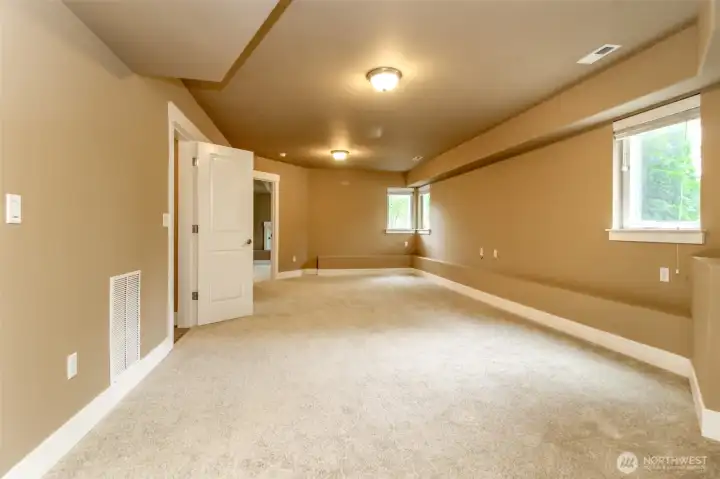 Large finished lower-level living space ideal for a media room, recreation area, fitness studio, home office or MIL uniat