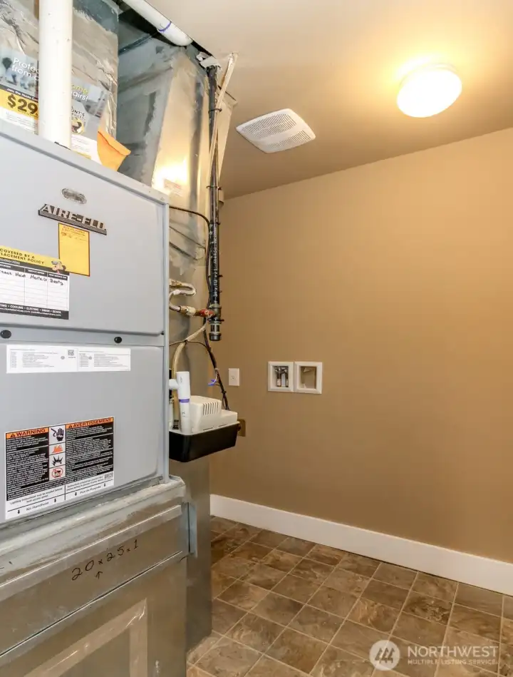 Well-maintained utility area featuring modern mechanical systems and additional storage potential with Washer hook up.