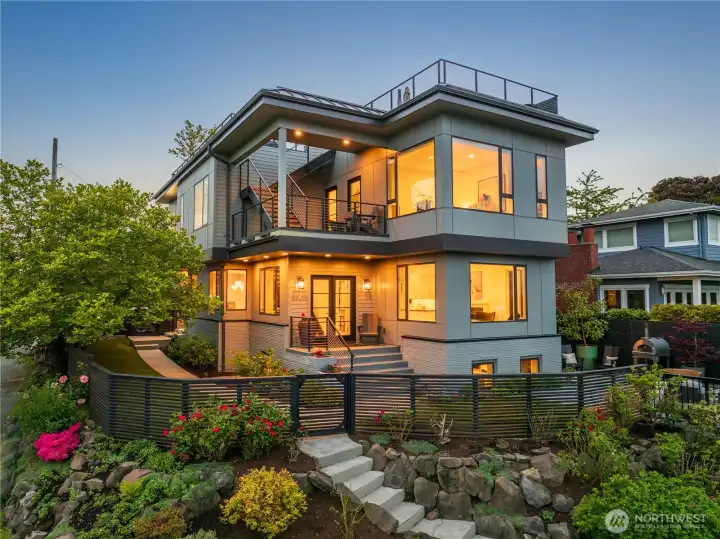 Perched on a coveted southeast corner lot, this stunning five-bedroom, four-bath custom contemporary home showcases sophisticated style, modern finishes, and breathtaking panoramic views spanning downtown Seattle, Elliott Bay, Mount Rainier, Mount Baker, the Cascades, and the Space Needle.