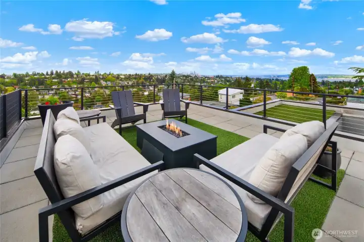 Expansive rooftop retreat offers unforgettable 360-degree views, turf flooring, BBQ station with patio, privacy screening, and mature landscaping—creating the ultimate space for entertaining and relaxing.