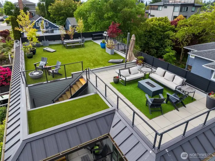 Expansive rooftop retreat offers unforgettable 360-degree views, turf flooring, BBQ station with patio, privacy screening, and mature landscaping—creating the ultimate space for entertaining and relaxing.