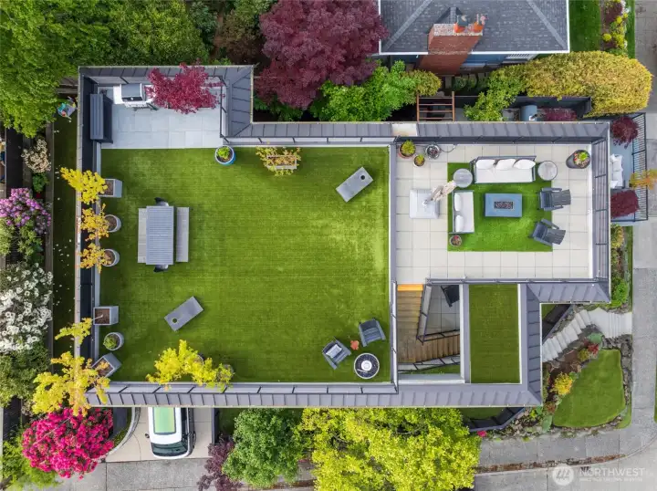 Expansive rooftop retreat offers unforgettable 360-degree views, turf flooring, BBQ station with patio, privacy screening, and mature landscaping—creating the ultimate space for entertaining and relaxing.