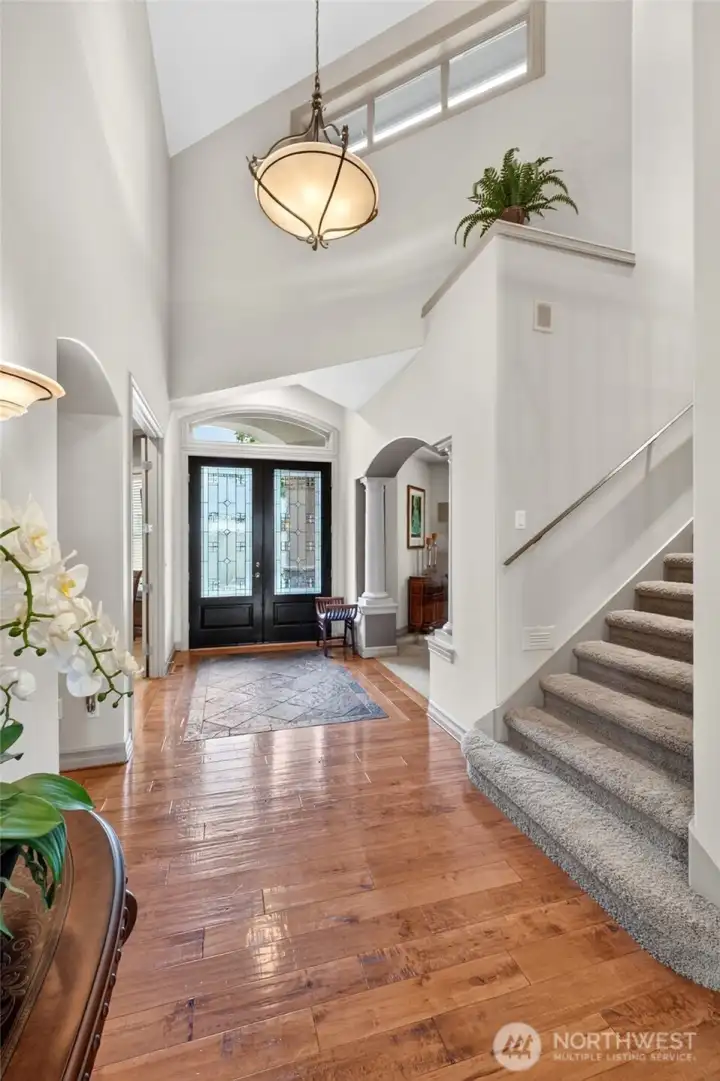 Beautiful entry with hardwood floors and ceramic tile