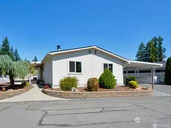 This delightful home will amaze you with its impeccably updated condition and the amazing covered backyard deck, plus an incredible indoor/outdoor rec room/kitchen area! You’ll own your own land here, and the charming neighborhood is delightful and beautifully maintained. Besides the great interior floor plan, you’ll love the additional pantry and storage room, plus a separate workshop area for all of your projects. There is a neighborhood clubhouse and RV parking available. Ample parking and a fenced backyard - everything you’ve dreamed of is here in this stellar home and great 55 and over community. (Some exceptions can be made for those under 55!) This delightful home will amaze you with its impeccably updated condition and the amazing covered backyard deck, plus an incredible indoor/outdoor rec room/kitchen area! You’ll own your own land here, and the charming neighborhood is delightful and beautifully maintained. Besides the great interior floor plan, you’ll love the additional pantry and storage room, plus a separate workshop area for all of your projects. There is a neighborhood clubhouse and RV parking available. Ample parking and a fenced backyard - everything you’ve dreamed of is here in this stellar home and great 55 and over community. (Some exceptions can be made for those under 55!)