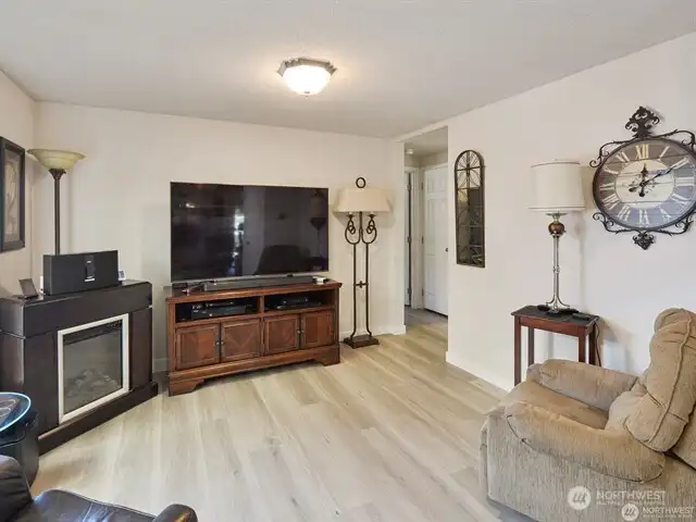 The family room, like the other living spaces, is graced with the newer Luxury Vinyl Plank flooring. The primary bedroom suite and another bedroom are at one one of the home, and the third bedroom is at the other end, allowing for privacy if you so wish. The family room, like the other living spaces, is graced with the newer Luxury Vinyl Plank flooring. The primary bedroom suite and another bedroom are at one one of the home, and the third bedroom is at the other end, allowing for privacy if you so wish.