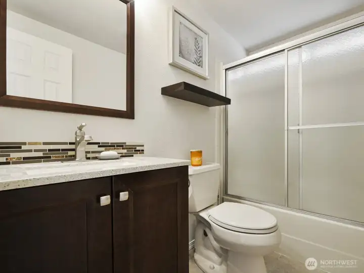 The main bathroom is roomy, gleaming, light and bright, and all ready for you!