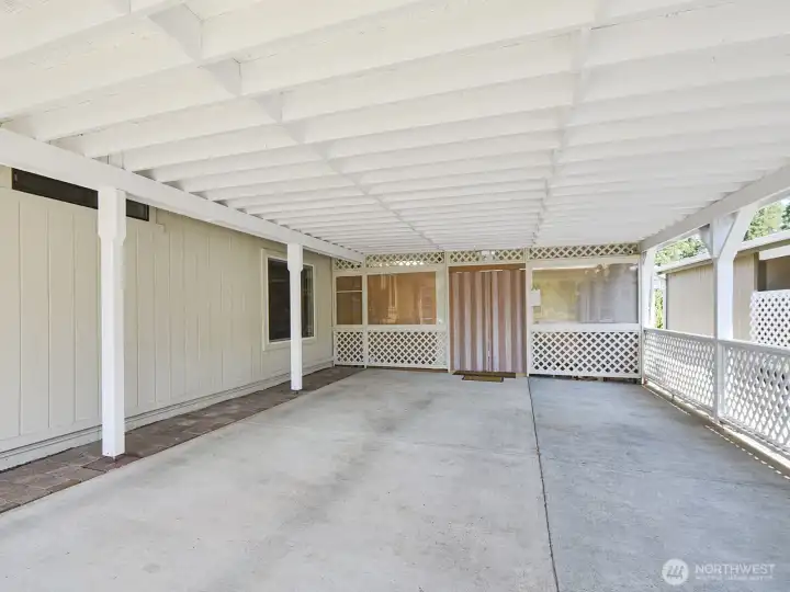 The covered driveway easily holds two vehicles, plus there is more off-street as well as street parking, AND a private lot for RVs, trailers or boat parking! Enter through the folding doors at the end of the driveway, and you enter a fabulous 'outdoor living space you'll find enchanting!