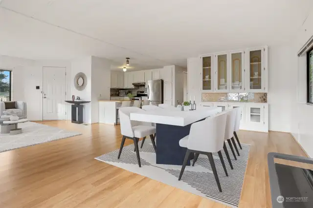 Formal dining room with laminate flooring and a built in hutch,  opens to the kitchen eating bar and living room.  Virtually staged photo