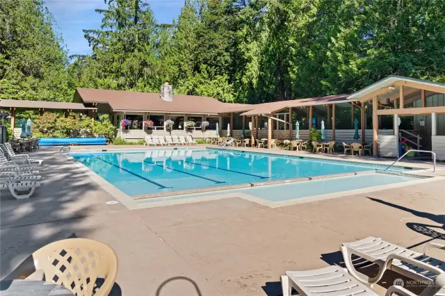 Seasonal pool outside clubhouse with changing rooms to right.