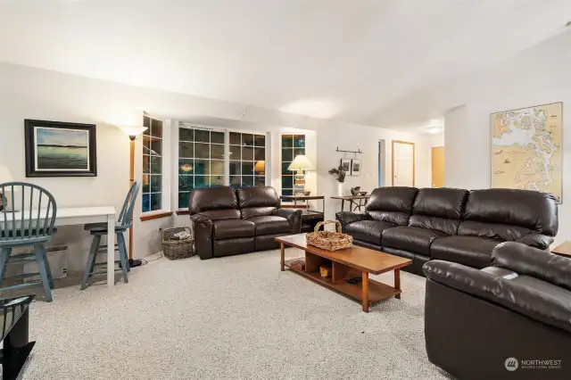 Living room with bay window towards entry.  Photos were taken after dark!