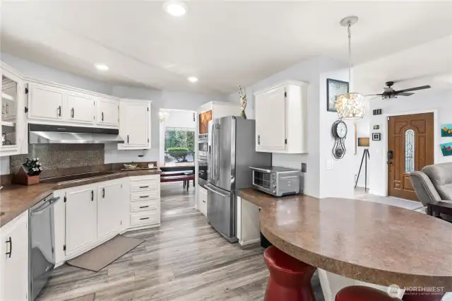 Kitchen with eating area, high end microwave and oven.