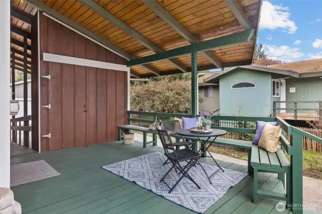 Great built in seating w/storage area.  This entire area could be enclosed to create more sq ft.  Behind this storage is a covered carport that could also be used for expansion.