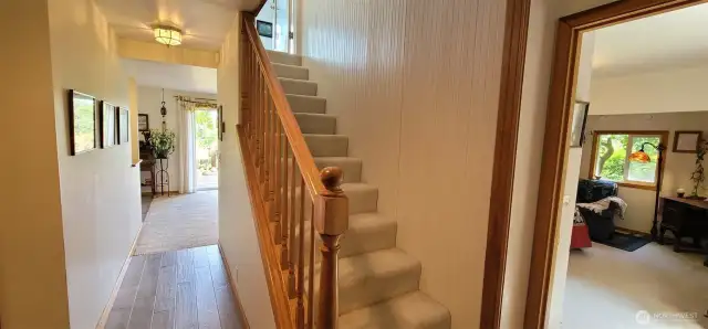 This light-filled landing strikes the perfect balance between function and charm—featuring a graceful staircase, warm wood accents welcoming guests upstairs. A thoughtfully designed space where everyday moments feel just a little more elevated.