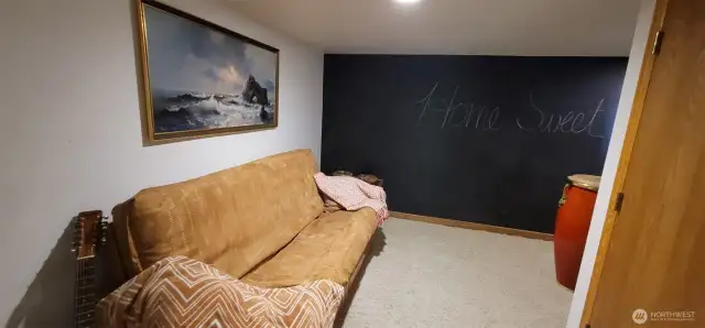 Versatile and inviting, this daylight basement with its own private entrance offers endless possibilities—use it as a guest bedroom, a cozy family lounge, or a playful retreat filled with music, games, and creativity. Thoughtful details like the chalkboard wall and warm lighting add personality, making it a flexible space that adapts to your lifestyle.
