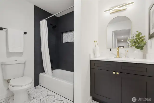 2nd full bath with updated tiling, new bath, cabinets and gold fixtures