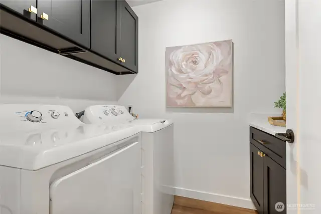 Functional laundry room with updated cabinets and quartz counter tops.