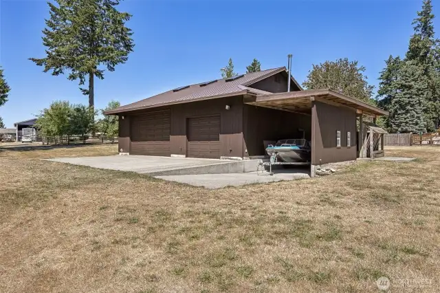 Across the lawn in front of the home, and through the gate is a 1440 square foot shop/barn/garage with toms of space to park toys, with RV parking, too!