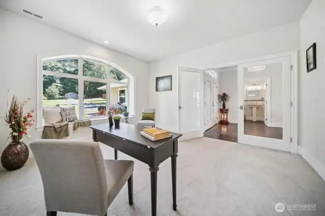 View of the Den/Office off of the Entry. Triple Pane Windows!  View of the front yard to the East.