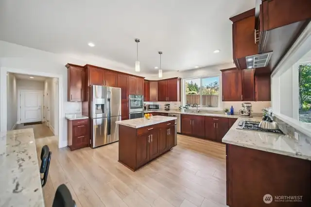 Kitchen - Main Floor.  Luxury Vinyl Plank Flooring, Granite Countertops, Cherry wood Cabinets, and Center Island.
