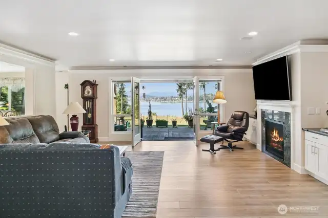 Great Room... open to the Kitchen, Classy Gas Fireplace with built-ins on both sides and a big screen to boot!  Luxury Vinyl Plank, Painted Trim, and flooded with sunlight!
