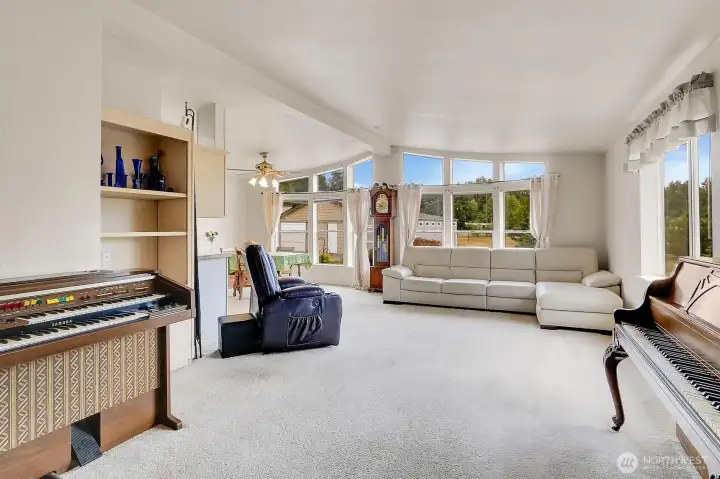 Bright, open bay windows bring in the natural light and highlight the amazing views from the home. * Recliner chair does not convey.