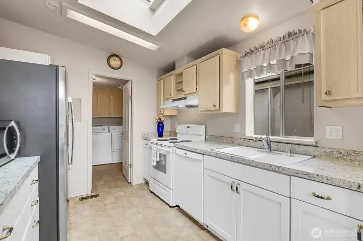 Vaulted ceilings, a big beautiful skylight, newer full-size fridge and range make cooking in this kitchen a dream!