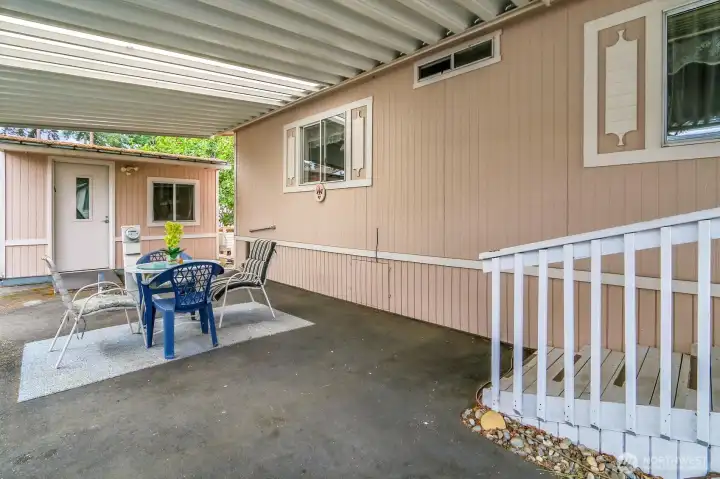 Covered 2-car (tandem) carport offers a sweet little dining area and room for 2 cars to park. Enjoy the outdoors all year long! 2 Large, insulated storage sheds/workshops with electricity are also included with the sale!