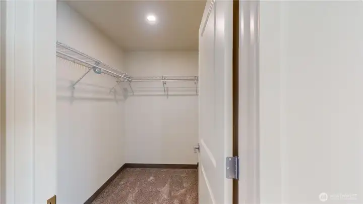 Layout of primary bedroom with ensuite to left and walk in closet