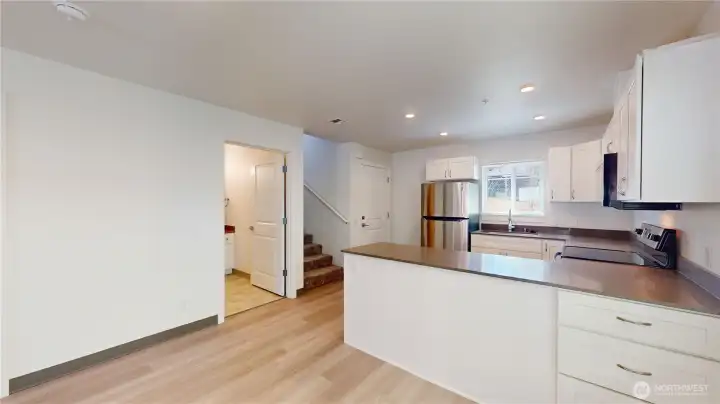 This unit  13813 has a small outdoor space with access right off he kitchen. Stairs to upstairs bedrooms and bath and bathroom on main floor shown here