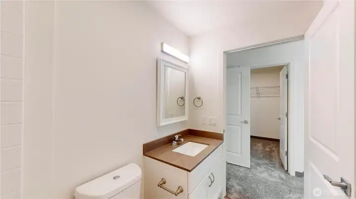 Primary bedroom ensuite looking into walk in closet