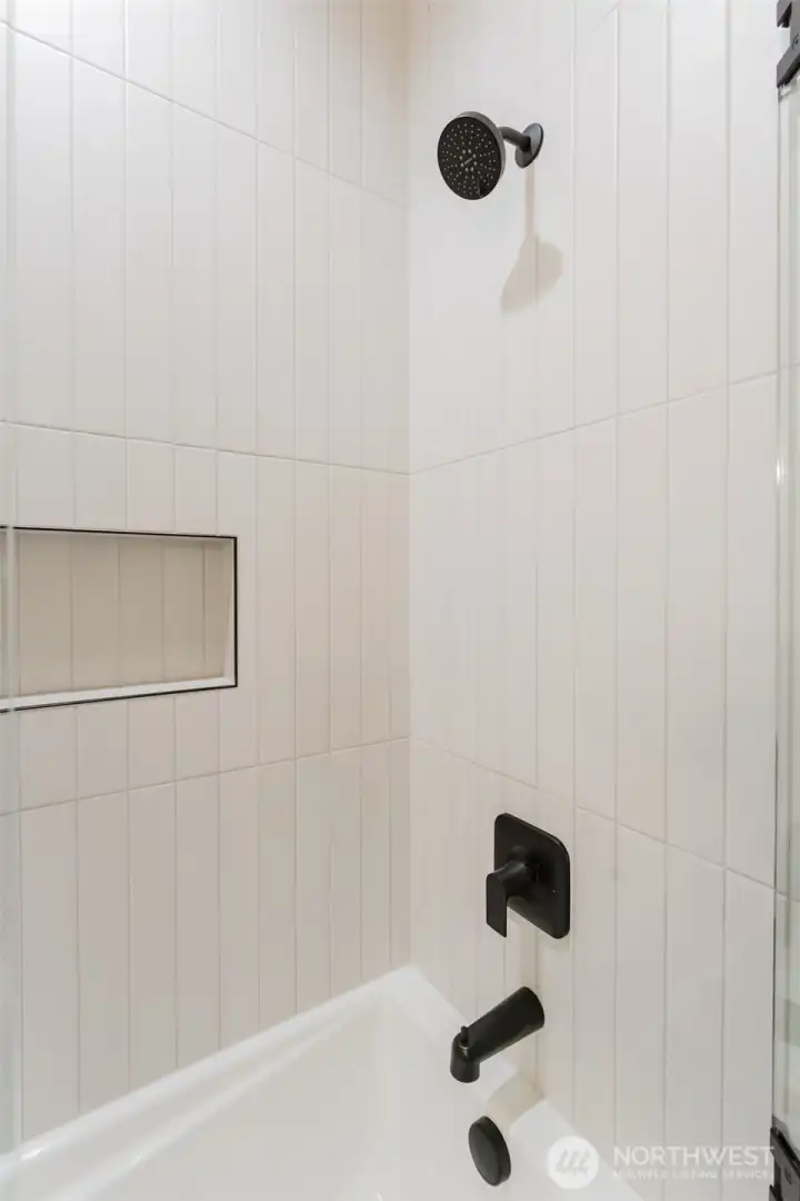 Large tub with tiled surround.