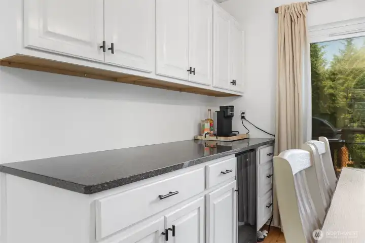Dining room features a built-in wine fridge and additional cabinetry~