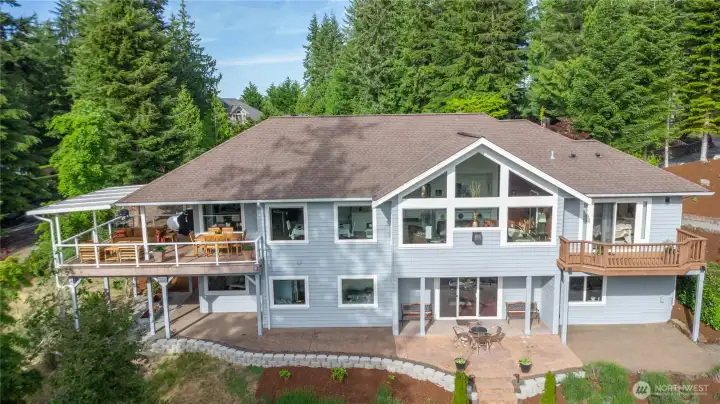 Incredibly well maintained and set on more than an acre, the exterior showcases refined outdoor living, beautifully curated private gardens, serene views, and flexible space ideal for work-at-home or multigenerational living.