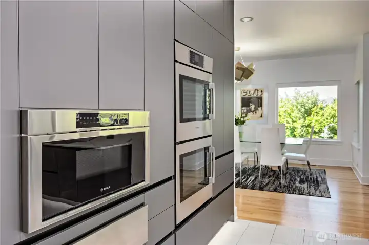 Stunning chef’s kitchen with dual Bosch ovens, warming oven, and custom cabinetry—designed for gourmet cooking and effortless entertaining.