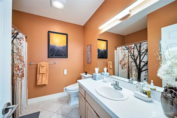 The lower level full bath is nicely updated and next to the two guest rooms. This "suite-like" area can be closed off from the lower level living room with a door.