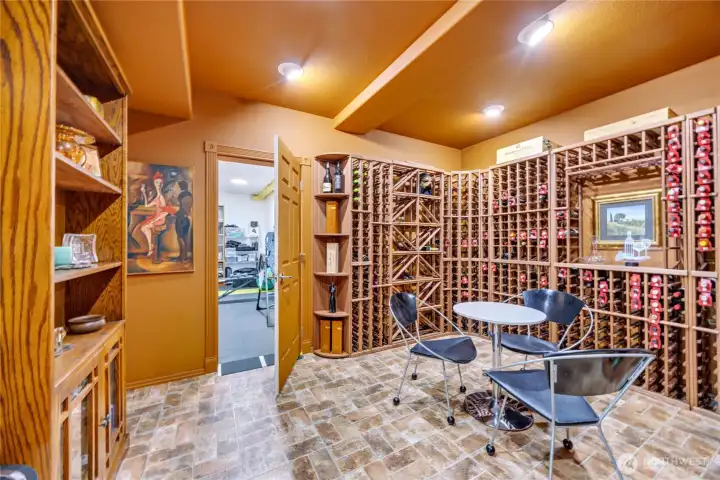 The large wine cellar is complemented by a finished adjacent room ideal for storage, exercise, or flexible use.
